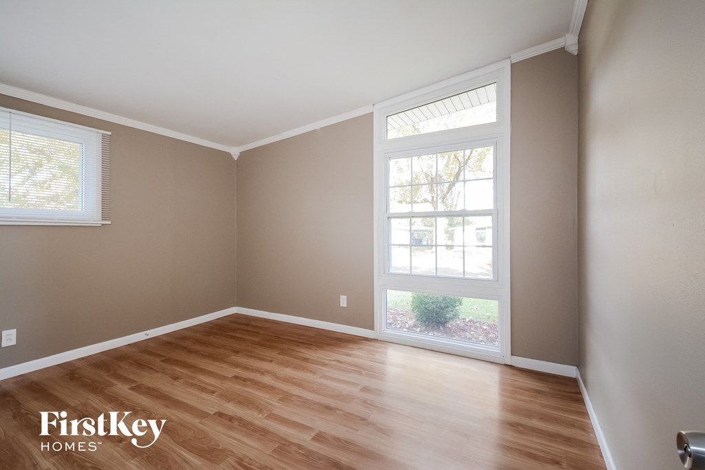 a living room with wood floors and a large window