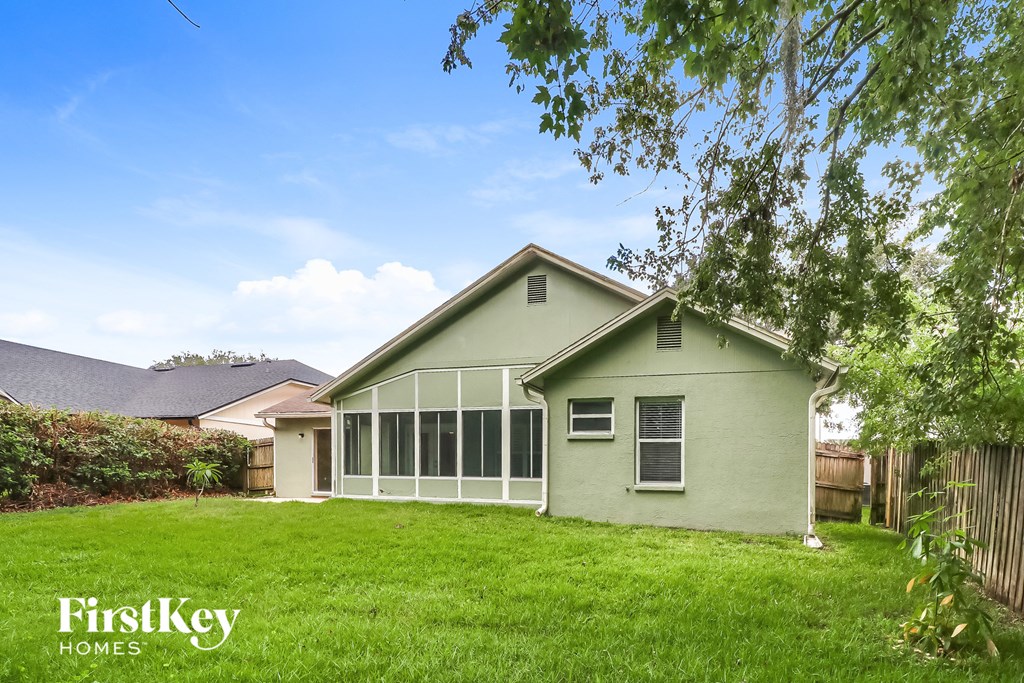 A house with a green lawn and a clear blue sky.