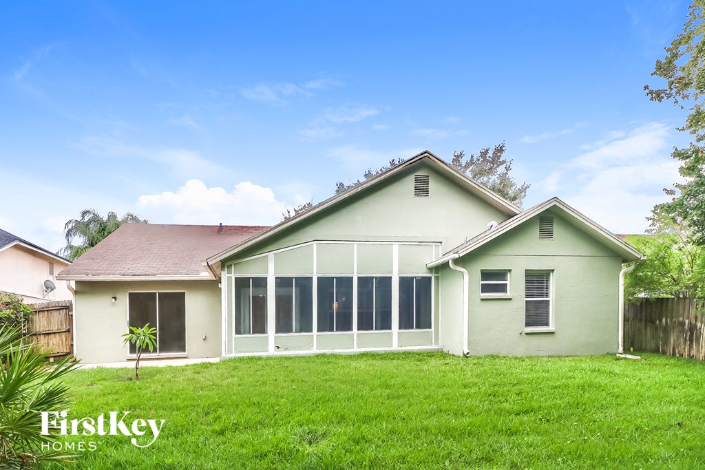 A house with a green lawn and a clear blue sky.