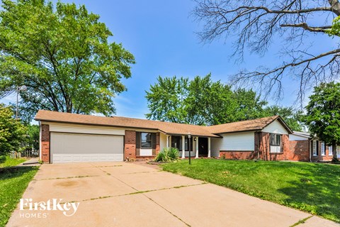 a brick house with a garage and a driveway