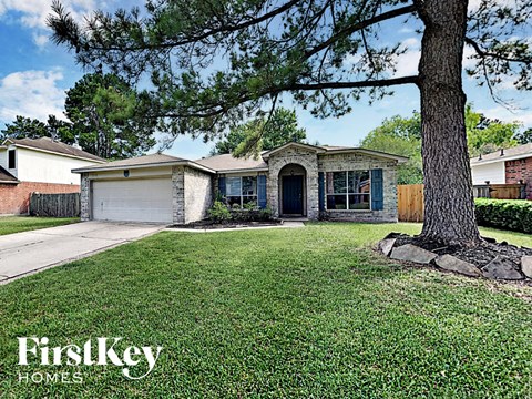 a house with a yard and a tree in front of it