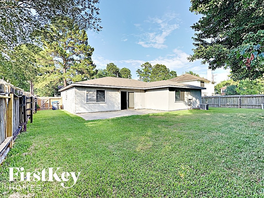 a small house with a yard and a fence