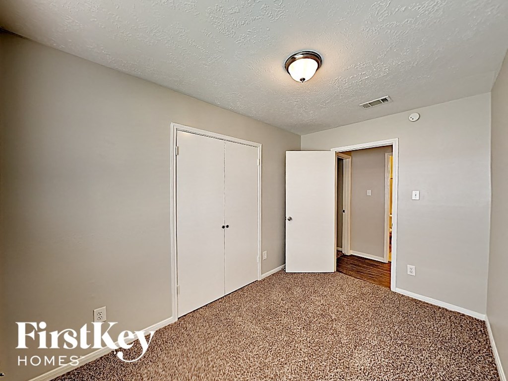 a bedroom with two closets and a door to a hallway