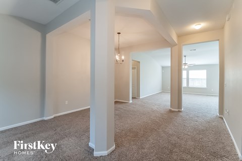 the living room and dining room of an empty house