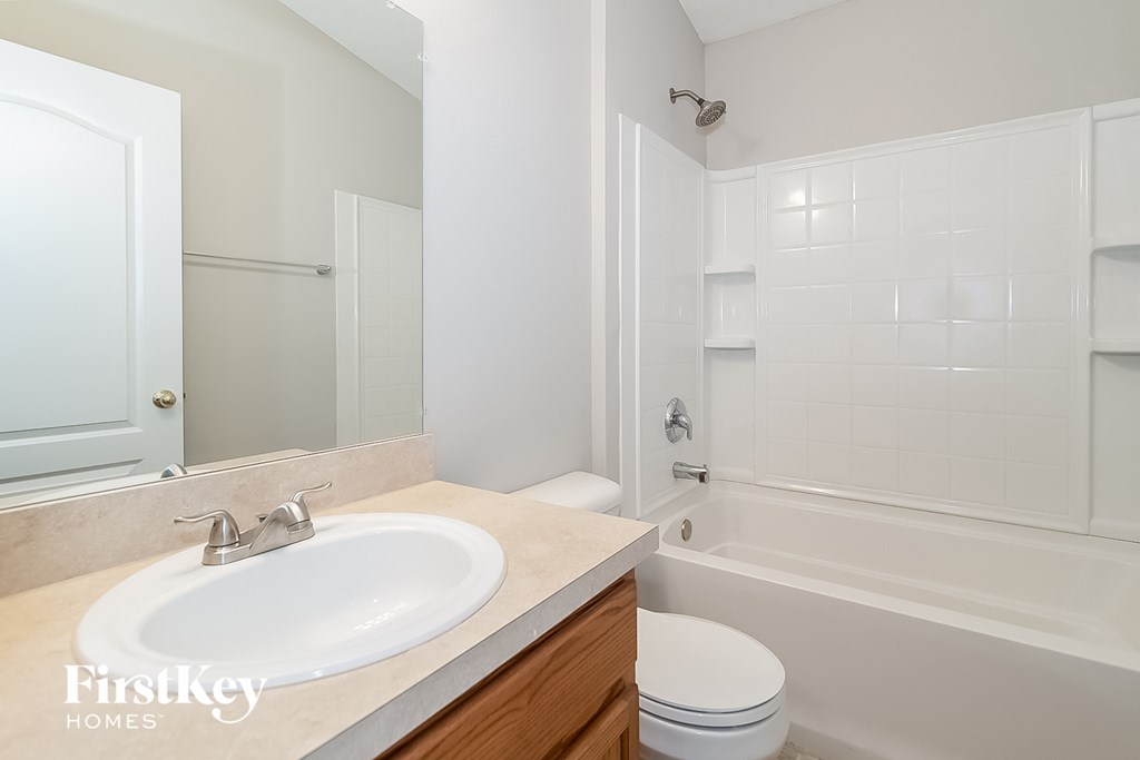 a bathroom with a sink and a tub and a toilet