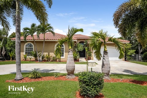 a house with palm trees in front of it
