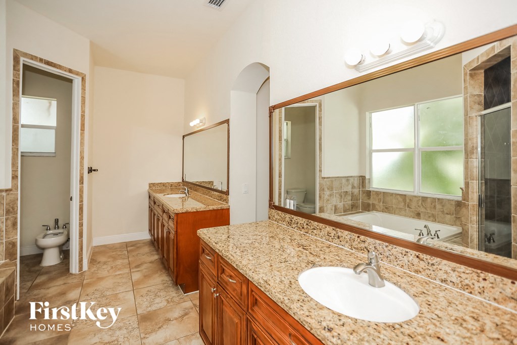 a bathroom with a sink and a bath tub and a mirror