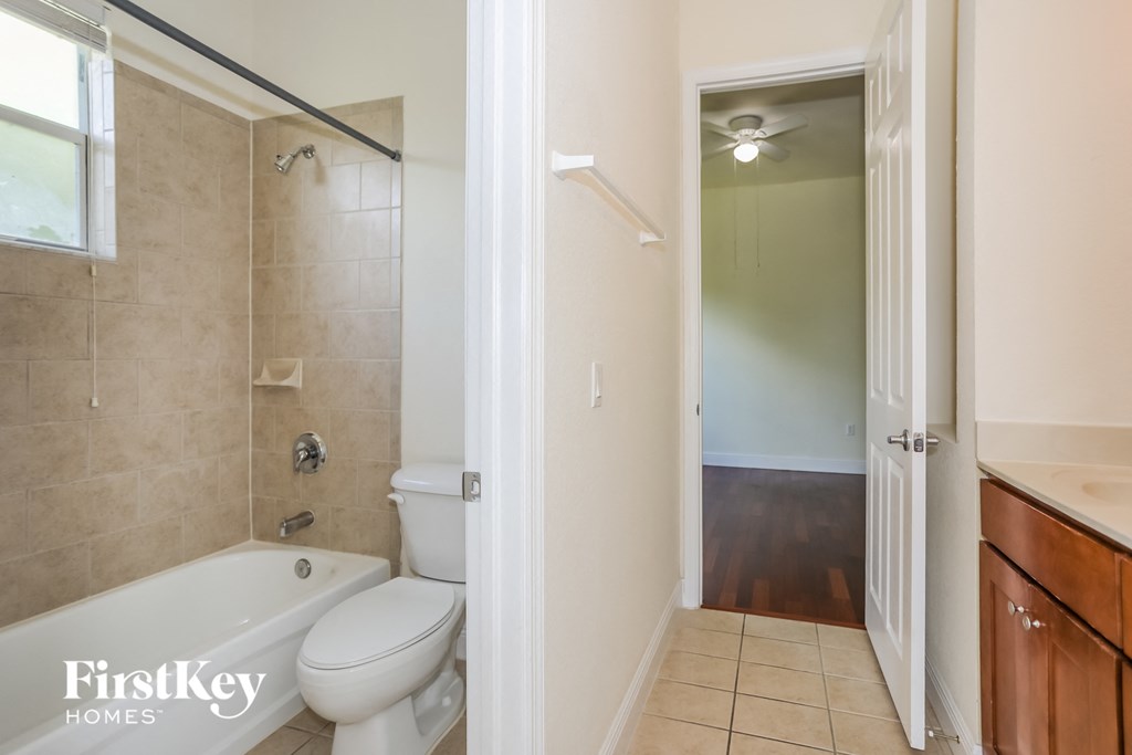 a bathroom with a toilet and a shower and a sink