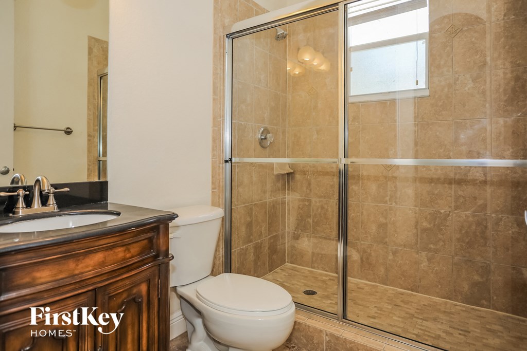 a bathroom with a shower toilet and sink