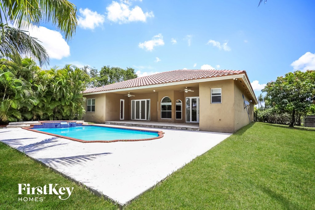 a backyard with a pool and a house