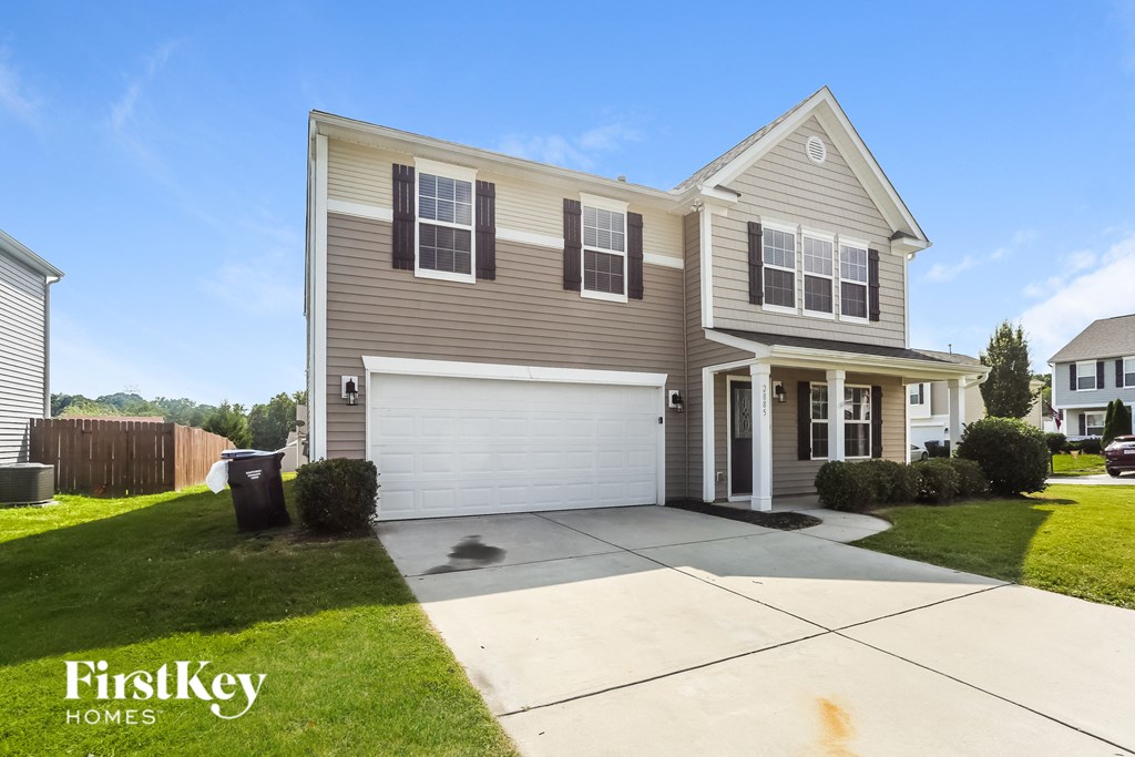 A two-story house with a garage is for sale by FirstKey Homes.