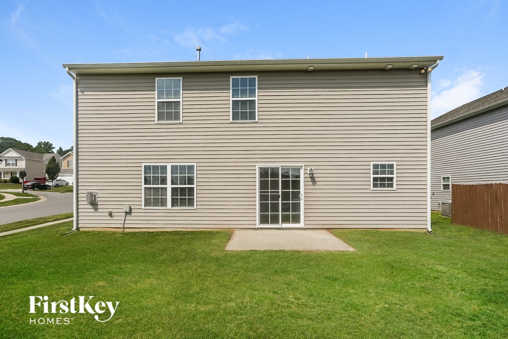 A house with a lawn in front of it.