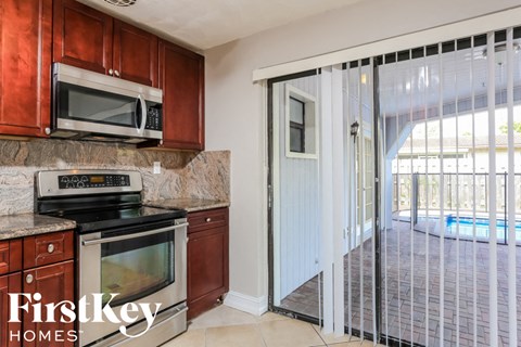 A kitchen with a stove top oven and microwave above it.