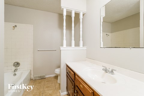 a bathroom with a sink and a tub and a toilet