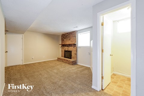 the living room of an empty house with a fireplace