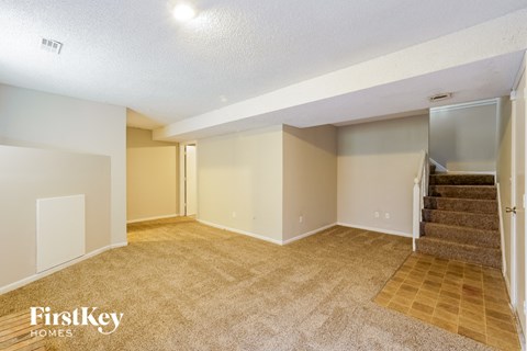 the living room and staircase of an empty house