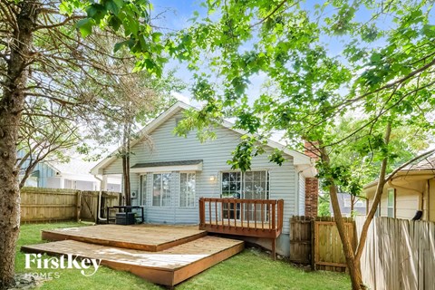 a backyard with a deck and a house