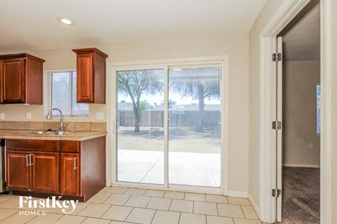 A kitchen with wooden cabinets and a sink is shown.