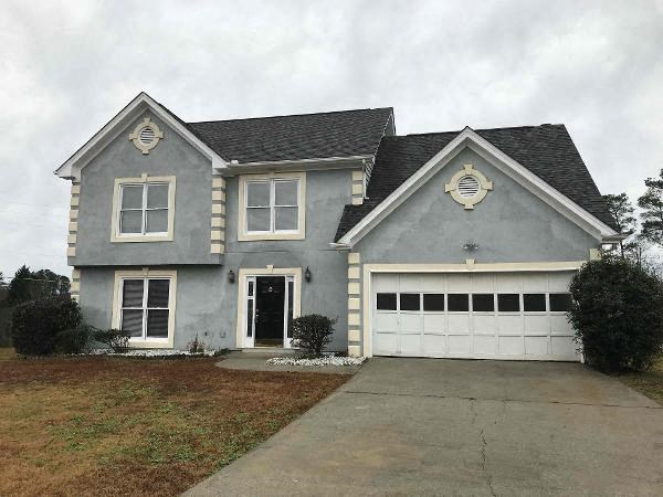 a gray house with a white garage door