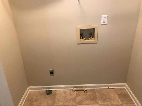 a empty room with a wall with a hole