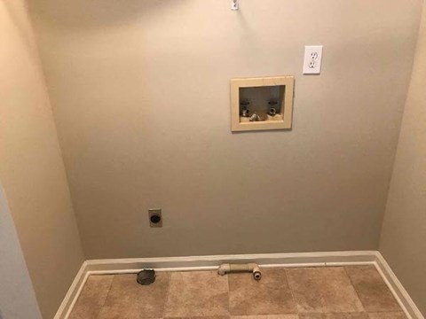 a empty room with a wall with a hole