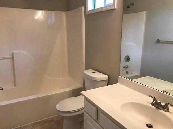 a bathroom with a sink toilet and a shower