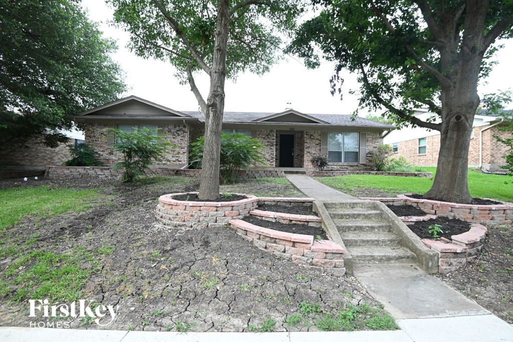 A house with a tree in front of it.