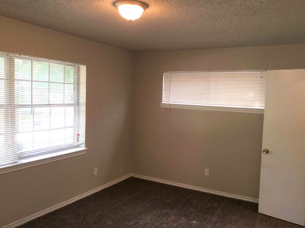 A room with a window and a door.