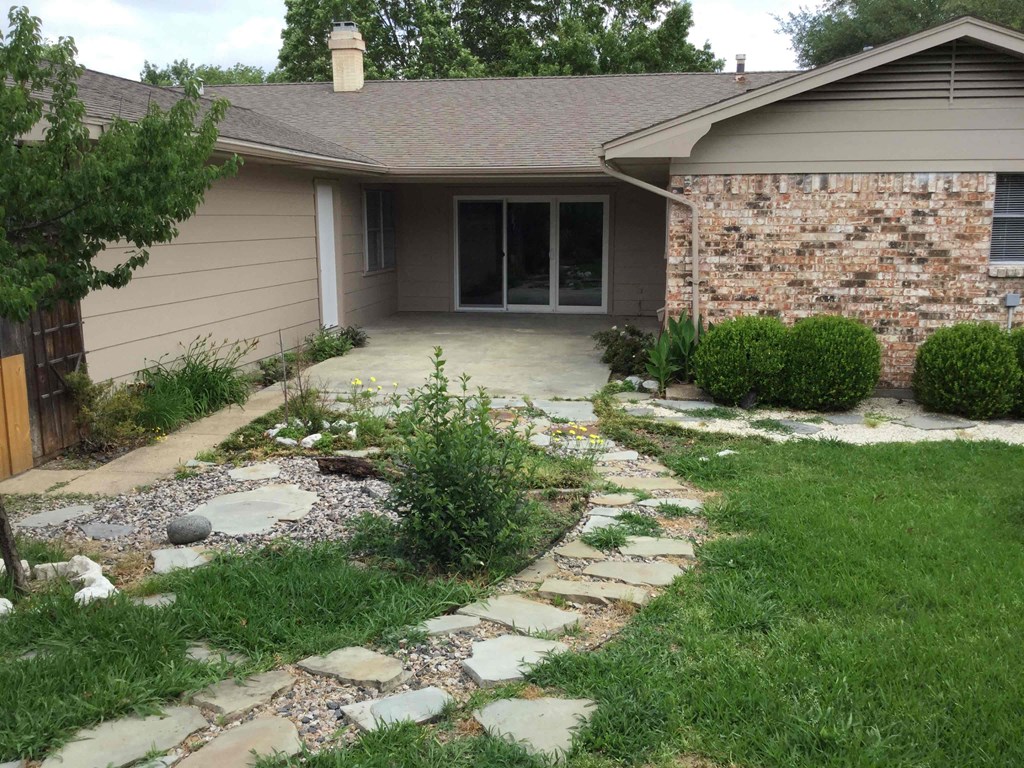 A house with a stone pathway leading to the front door.