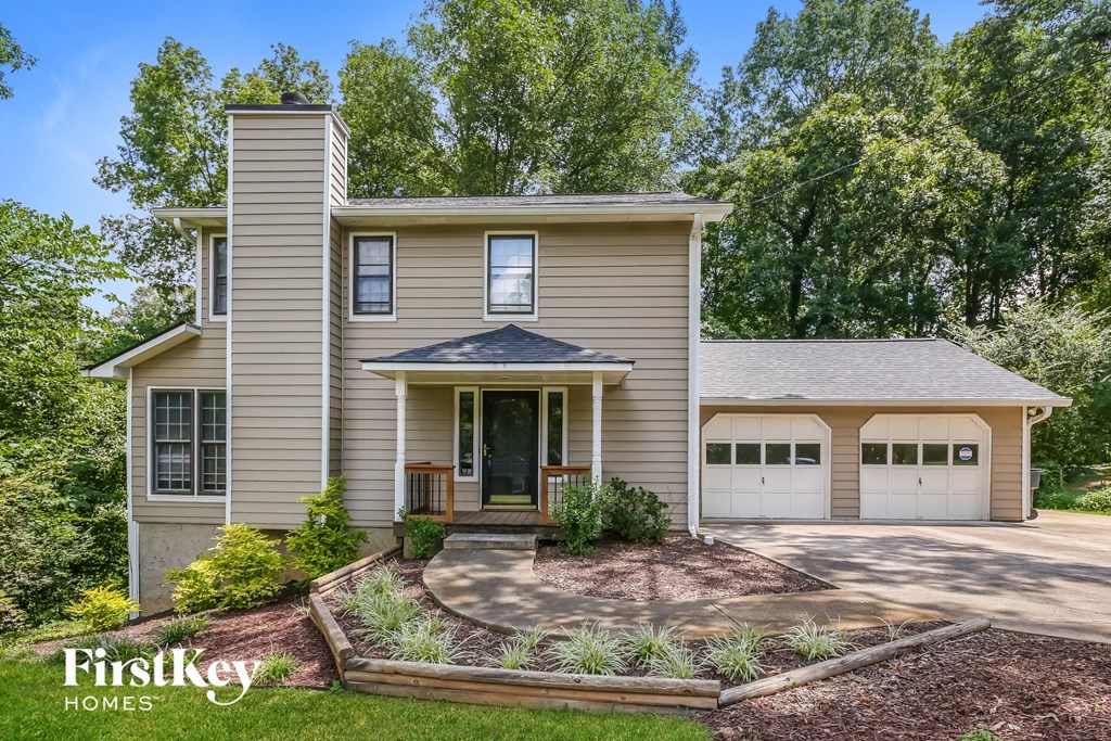 a house with two garage doors and a driveway