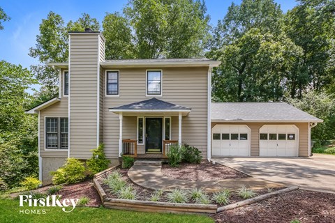 a house with two garage doors and a driveway