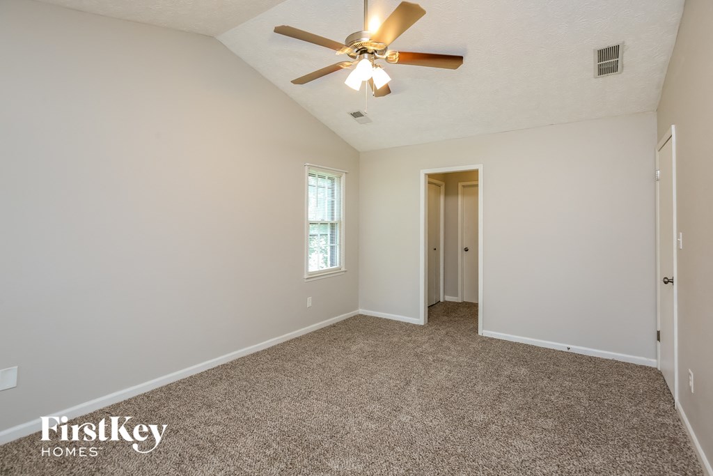 the master bedroom is spacious and has a ceiling fan