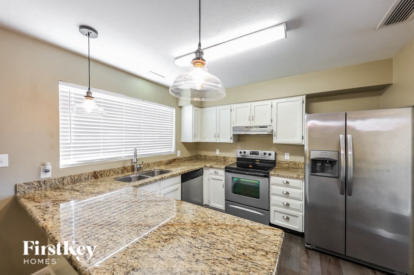 a kitchen with granite counter tops and stainless steel appliances