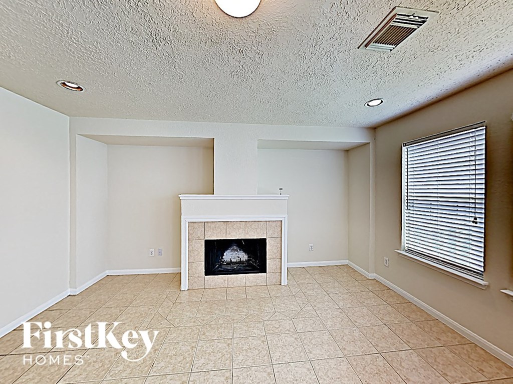 a living room with a fireplace and a window