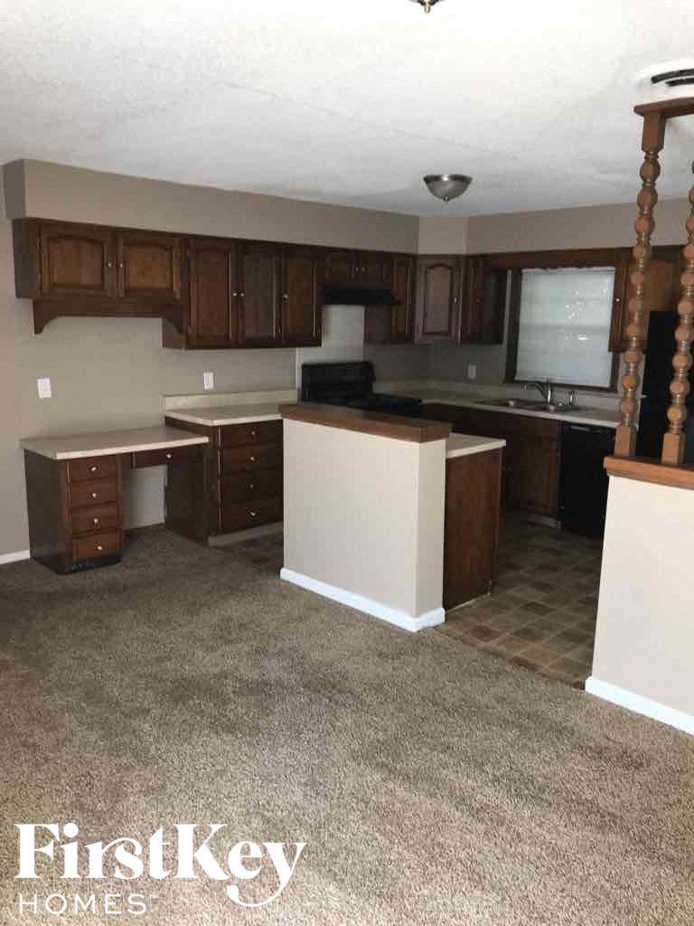 A kitchen with brown cabinets and a white island.