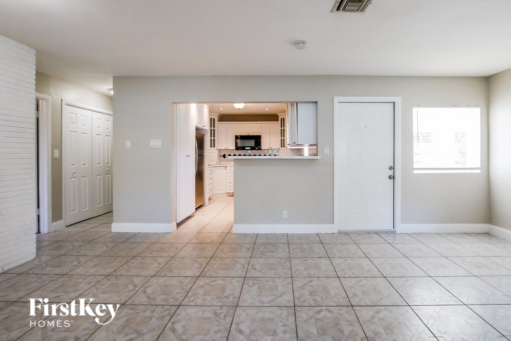 an empty living room and kitchen in a house