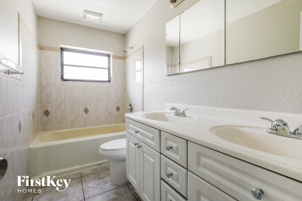a bathroom with a sink and a toilet and a tub