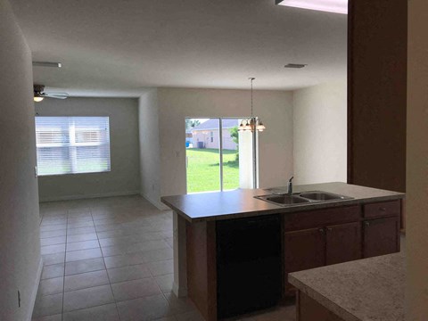 A kitchen with a sink and a window.