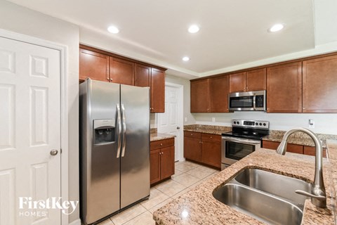 a kitchen with stainless steel appliances and granite counter tops