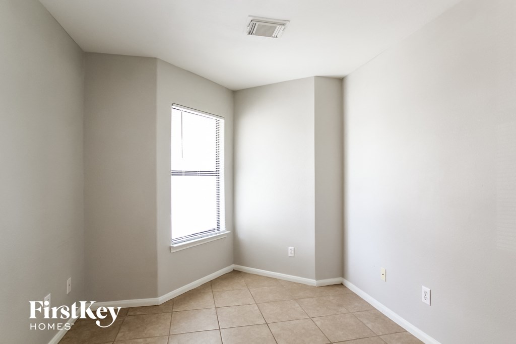 an empty room with white walls and a window