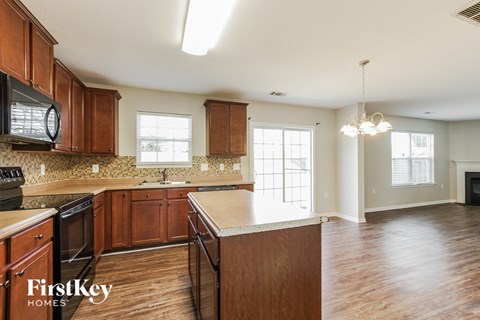 a kitchen with wooden cabinets and a white counter top