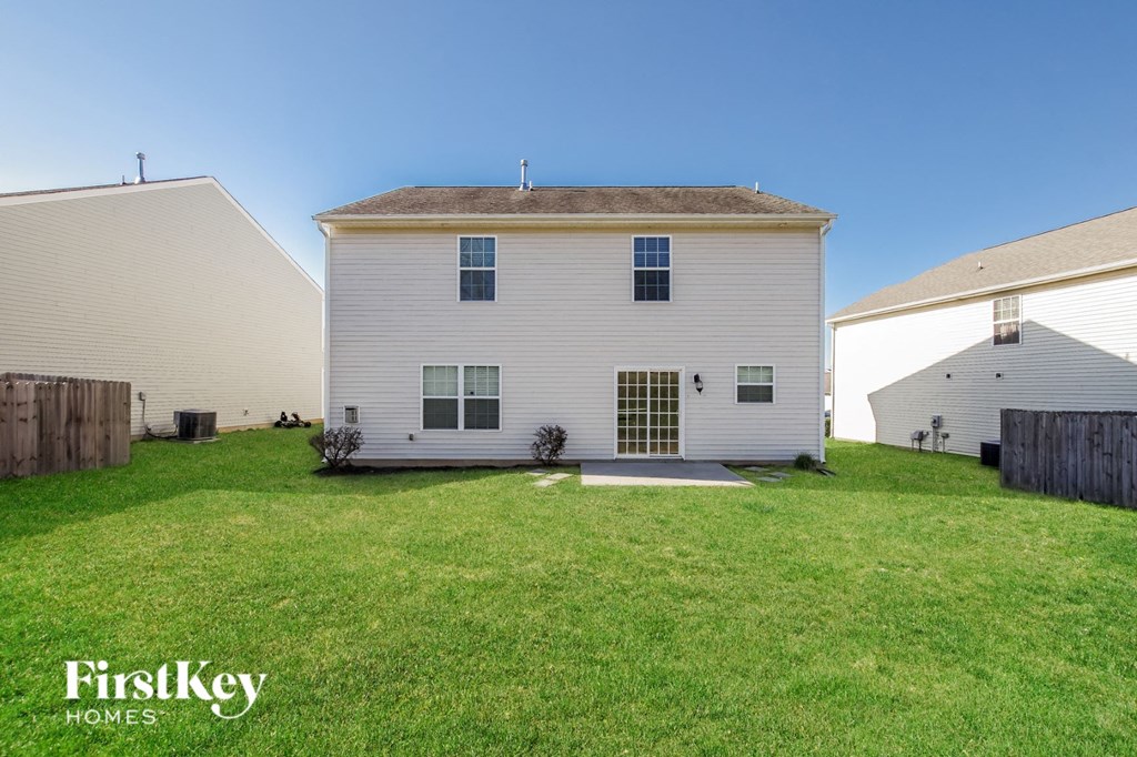 a white house with a green lawn in front of it