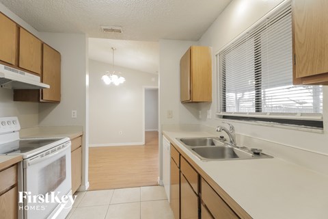 a kitchen with a sink and a stove and a window