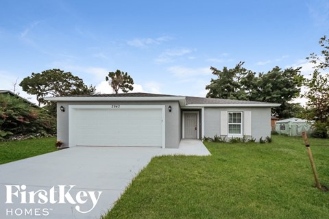 A white house with a garage is shown with the words "FirstKey Homes" on the bottom left.