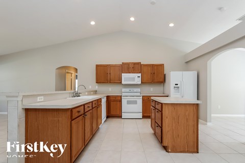 A kitchen with wooden cabinets and a white refrigerator.