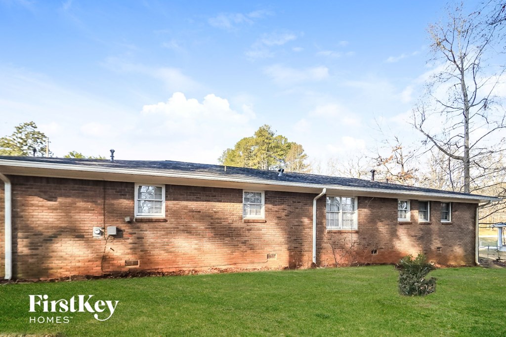 the front of a brick house with a blue roof