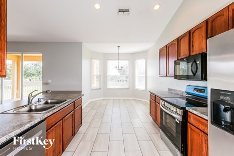 A kitchen with wooden cabinets and a stainless steel oven.