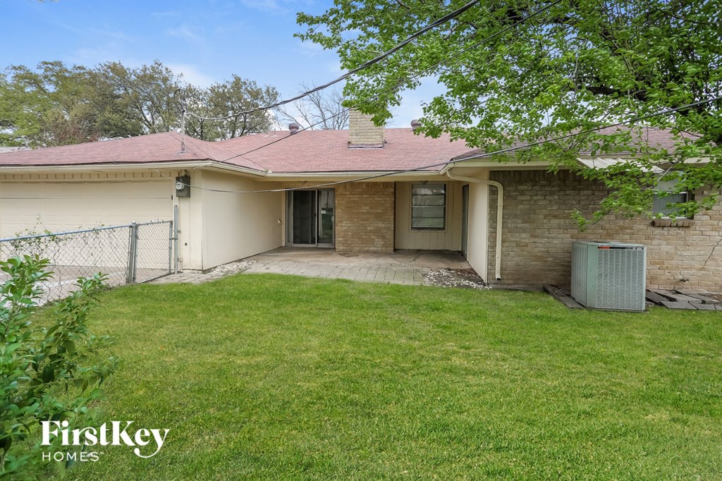 a small house with a yard and a fence
