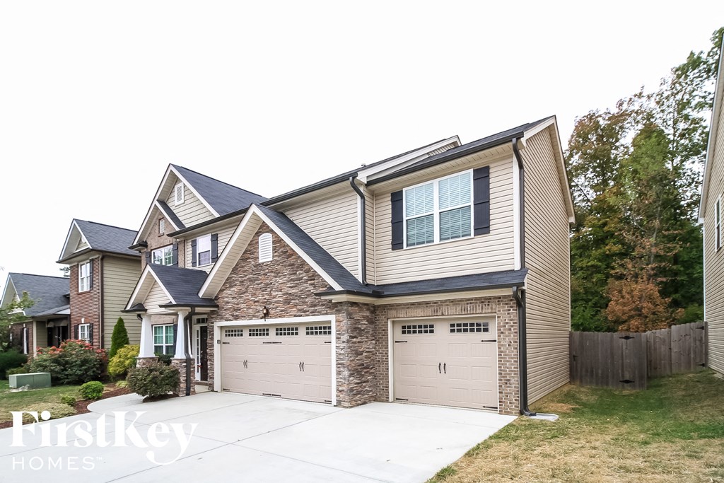 A two-story house with a garage is for sale.