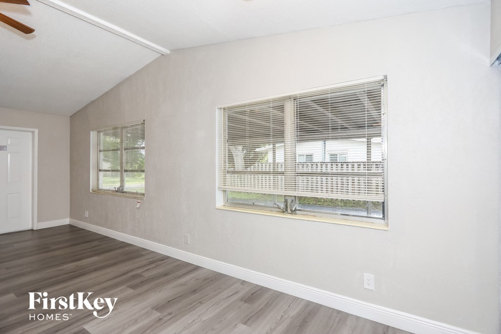 A room with a window and a ceiling fan.